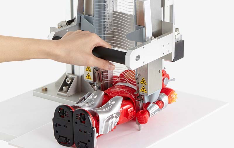 IndES Elastic Staple System securing a toy robot to packaging